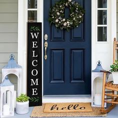 a blue front door with a welcome sign on it