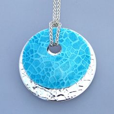 Lake Bed enamel pendant necklace has two circle embossed discs, one colored turquoise, one sterling silver. Silver Enamel Round Pendant Necklace, Silver Enamel Oval Pendant Necklace, Silver Enamel Oval Pendant Necklaces, Round Enamel Necklaces With Large Pendant, Silver Enamel Necklace With Oval Pendant, Silver Enamel Necklaces With Oval Pendant, Enamel Techniques, Colored Water, Themed Jewelry