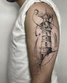 a man with a lighthouse tattoo on his arm