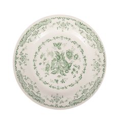 a green and white plate with floral designs on the rim, against a white background