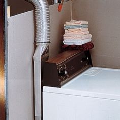 a stack of towels sitting on top of a dryer