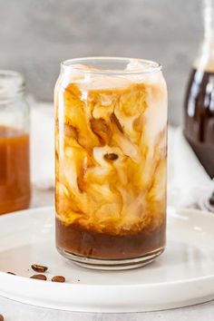 a jar filled with liquid sitting on top of a white plate