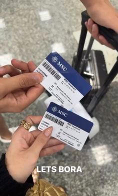 two people exchanging tickets to each other at an airport