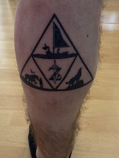 a man with a tattoo on his leg that has animals and boats in the triangle