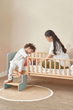 two children playing in a small wooden bed