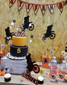 a table topped with a cake and cupcakes