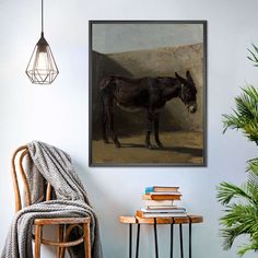 a painting of a horse in a rocky area by a table with books on it