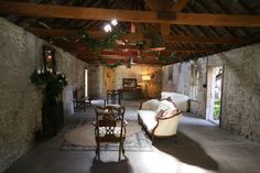 a living room filled with furniture and stone walls