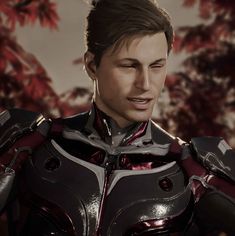 an image of a man in armor looking to his left with red leaves behind him