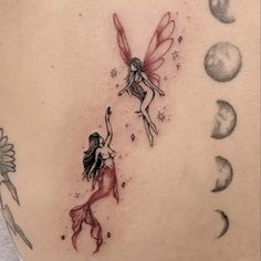 a woman's back with a tattoo on it that has two fairy tinkerbells flying over the moon and stars