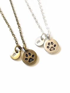 >>> Keep the memory of your pets close to your heart when you wear this special paw print necklace.>>> Whether for yourself or someone else, every order is creatively packaged and ready to gift.>>> This necklace is made with cable chain and a Tierracast pewter paw print charm. Dangles from an 18" cable chain; finished with lobster clasp closure.>>> Customize with your preferred metal finish - antiqued brass or copper, or gold or silver plated. Brass and silver are pictured in main listing photo, Silver Paw Print Jewelry For Personalized Gift, Personalized Silver Jewelry With Paw Print, Silver Jewelry With Paw Print For Personalized Gift, Paw Print Round Pendant Jewelry For Gift, Paw Print Round Pendant Jewelry As Gift, Paw Print Round Pendant Jewelry Gift, Round Pendant Necklace With Paw Print For Gift, Dog Memory, Dog Memorial Jewelry