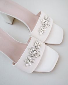 Classic satin slip on block heel sandals with the sparkly combination of this marquise and rhinestones brooch adds an elegant sparkle for casual and dressy look. Simple and easy wear for bridal wear, bridesmaids, holiday party, wedding parties, and any special occasions. DETAILS: HEEL HEIGHT: 2.5 InchesCOLORS AVAILABLE: Ivory and WhiteUPPER: Synthetic upper and liningMATERIALS: Manmade outsole Elegant Embellished Wedding Shoes For Bridesmaid, Elegant Embellished Bridesmaid Wedding Shoes, Elegant Embellished Block Heel Wedding Shoes, Elegant Embellished Heels For Wedding, Glamorous Low Heel Wedding Sandals, Glamorous Wedding Sandals With Low Heel, Elegant Embellished Sandals For Wedding, Chic Embellished Sandals For Wedding, Elegant Embellished Wedding Sandals