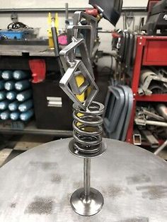 a metal object sitting on top of a table in a room filled with other tools