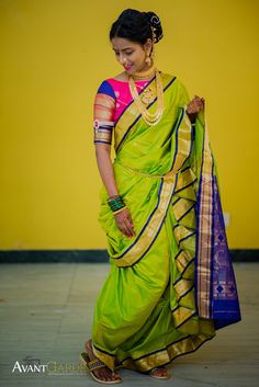 a woman in a green and yellow sari