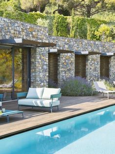 an outdoor living area next to a swimming pool