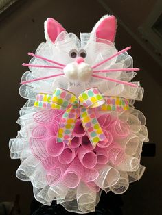 a close up of a stuffed animal made out of tulle and mesh with a bow