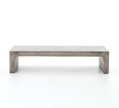 a concrete bench sitting on top of a white floor