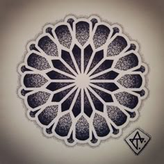 a drawing of a flower on a white wall with the letter a in it's center