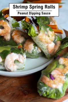 shrimp spring rolls on a plate with carrots and lettuce