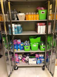 the shelves are full of cleaning supplies and other household care products in green bins