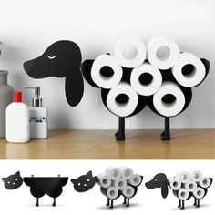 several toilet rolls are stacked on top of each other in front of a black and white dog