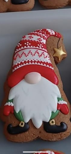 some cookies decorated like santa clause with decorations on them