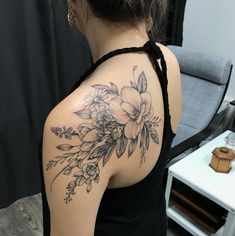 a woman with a flower tattoo on her shoulder