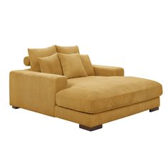 a tan chaise lounge with pillows on it