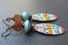 "Fantastic, colorful enameled copper spears, by the talented Patricia at verreetcuivre, are the main feature of these tribal earrings. The enameled copper charms sport an ethnic graphic pattern of swirls, lines, grids and dots in shades of aqua blue, mustard yellow, black and rust against a white background. Atop the spear shaped charms are dark pewter bead caps in a rustic petal design with raised dots. Above these are teal blue hand-made polymer clay bicone beads by mysticpeasantbeads. The col Bohemian Multicolor Enamel Earrings, Spear Earrings, Tiny Gold Earrings, Blue Wedding Jewelry, Gold Round Earrings, Small Dangle Earrings, Silver Chain Earrings, Minimalist Earrings Gold, Warrior Women