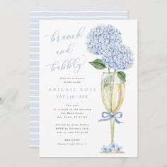 a blue and white striped wedding card with hydrangeas in a vase on the front