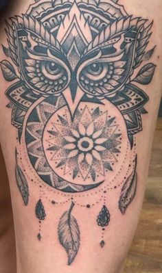 an owl tattoo on the thigh