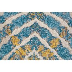 a blue rug with yellow and white designs on it