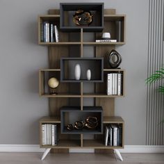 a book shelf with many books and other items on it in the corner of a room