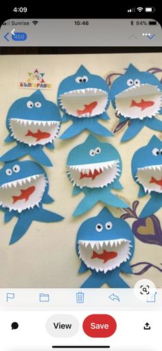 some paper cut outs with shark faces on them, and one is missing the teeth