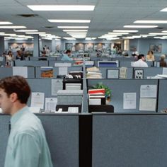 an office cubicle with people working on computers