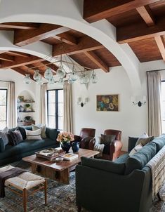 a living room filled with furniture and lots of windows