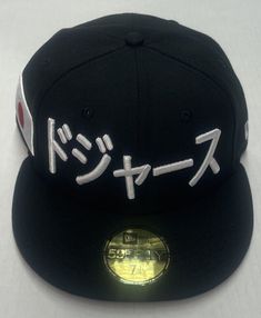 Show your love for the LA Dodgers and Japan with this unique New Era 59FIFTY fitted hat featuring a side patch with Japanese writing and a flag theme. Made of polyester with a black color, this hat is perfect for casual occasions during the summer season. The hat size is 7 1/8 and the brand is New Era, known for their quality hats and attention to detail. It is a great addition to any men's accessories collection and a must-have for LA Dodgers fans. Japanese Writing, Dodgers Fan, Quality Hats, New Era 59fifty, Accessories Collection, Fitted Hat, Men's Accessories, Summer Season, Fitted Hats