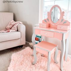 a pink vanity table and chair in a room with a white rug on the floor