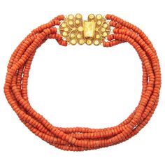 An antique 19th century natural coral necklace created with an impressive large worked 14 karat gold clasp. The clasp is beautifully made of fine filigree and cannetille work, the craftsmanship is stunning. The closure of the clasp is engraved with a floral design. The five strands are set with natural coral barrel-shaped beads and strung with red thread, the thread is not knotted between the beads. The coral is of good quality and has a beautiful color- Corallium Rubrum. In the 16th century, the traditional costume was created in the Netherlands, including jewelry made of coral, which lasted until the 20th century. These types of jewels represent a varied and rich historical Dutch cultural heritage, worn by women in some parts of the Netherlands. This type of necklaces were especially wor Gold Tassel Necklace, String Necklace, Red Coral Necklace, Coral Beads Necklace, Multi Strand Beaded Necklace, Nugget Necklace, Gold Bead Necklace, Vintage Necklaces, Fringe Necklace