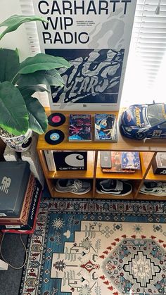 a room with a rug and various items on it