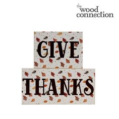 two wooden blocks with the words give thanks written in black and orange leaves on them