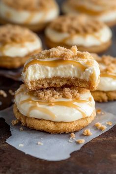 two desserts with frosting and crumbs on top of each other sitting on wax paper