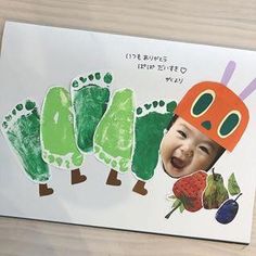 a child's hand and foot print with the image of a caterpillar