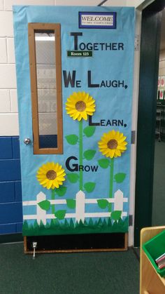 a classroom door decorated with sunflowers and the words together we laugh, learn, grow