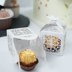 there are two boxes that have some cupcakes inside of them on the table