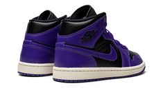 The Women’s Air Jordan 1 Mid “Black/Purple” is a women’s-exclusive colorway of the popular lifestyle shoe in a two-tone, purple and black design.  A head-turning look for the Jordan 1 Mid, the “Black/Purple” features a black leather base with contrasting Concord-colored leather overlays and Swoosh branding.  A black “Wings” logo appears on the collar while a purple Jumpman is found on the tongue tag.  Underfoot, the shoe is complete with a Sail rubber midsole that gives the shoe a vintage look a Jordan 1 Mid Black, Air Jordan 1 Mid Black, Sneakers Box, Kobe Shoes, Nike Air Jordan 1 Mid, Wings Logo, Sneaker Release, Purple Shoes, Black Wings