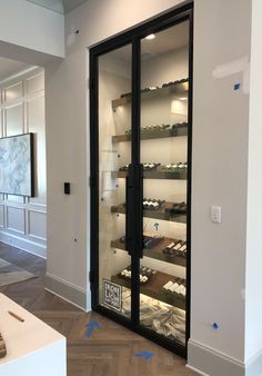 an empty shoe store with glass doors and shelves