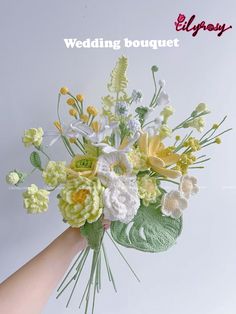 a hand holding a bouquet of flowers on top of a white background with the words, wedding bouquet