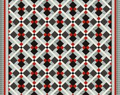 a black and white quilt with red accents on the border, in front of a gray background