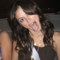 a woman making a funny face with her tongue out